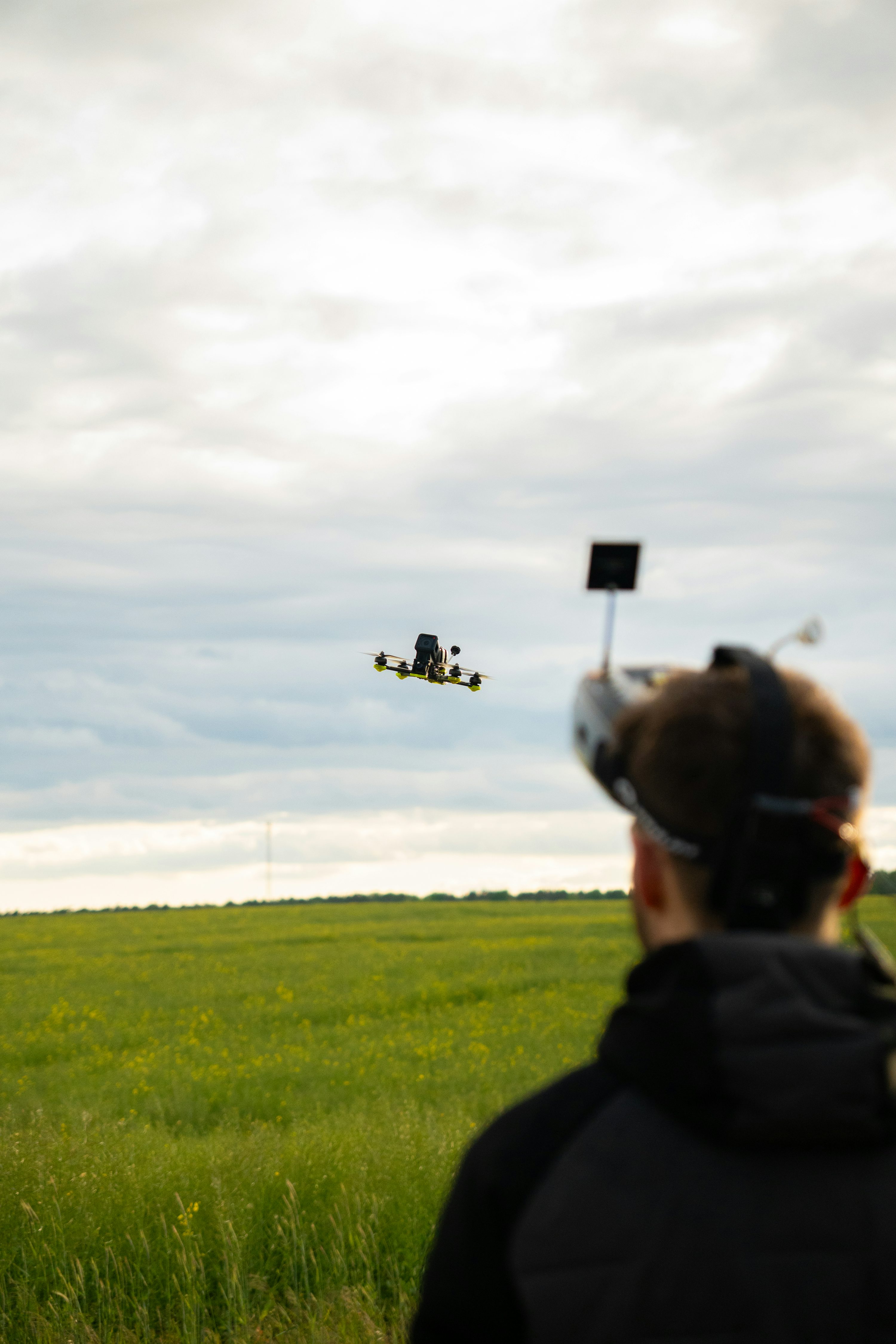 FPV pilot flying on an open field
